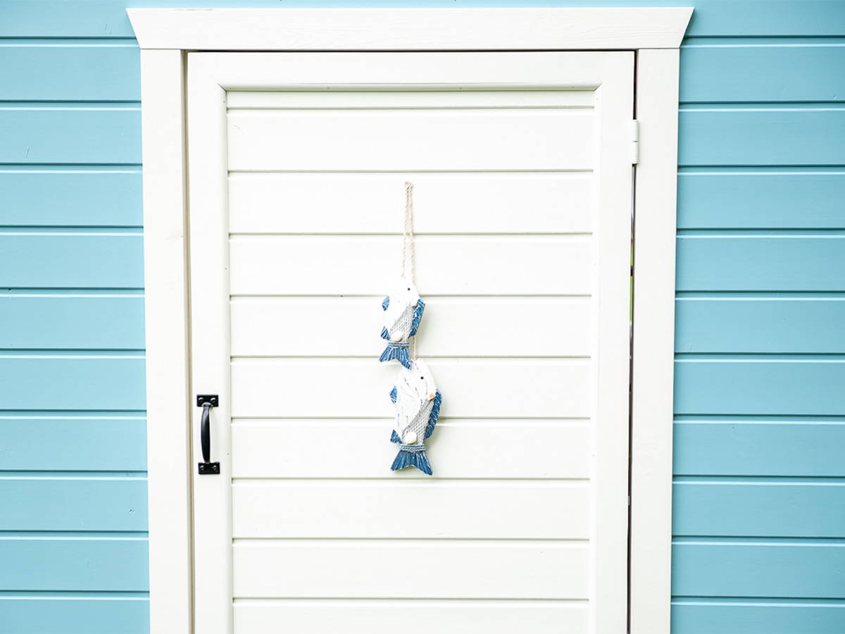 Blue and white Outdoor Playhouse close up of wooden door with decoration by WholeWoodPlayhouses