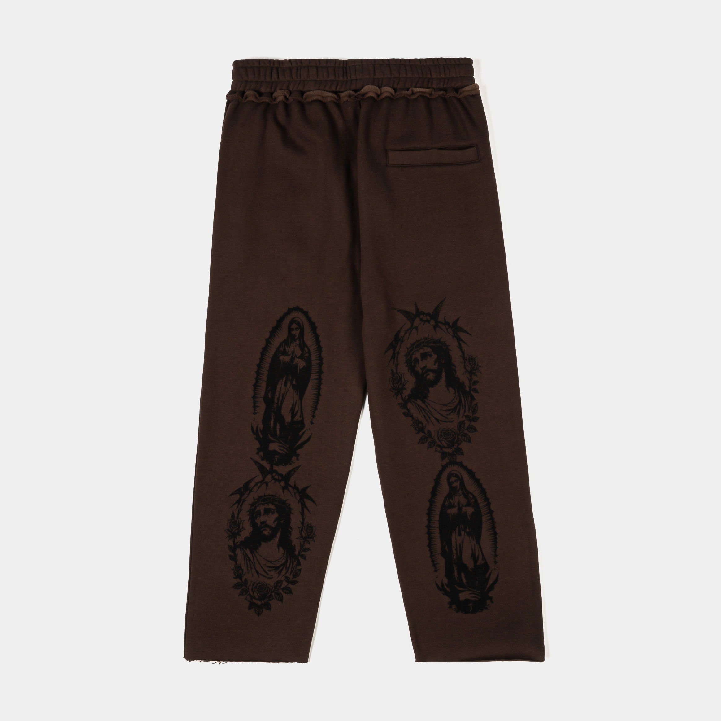 Brown pants featuring black graphic designs of figures.