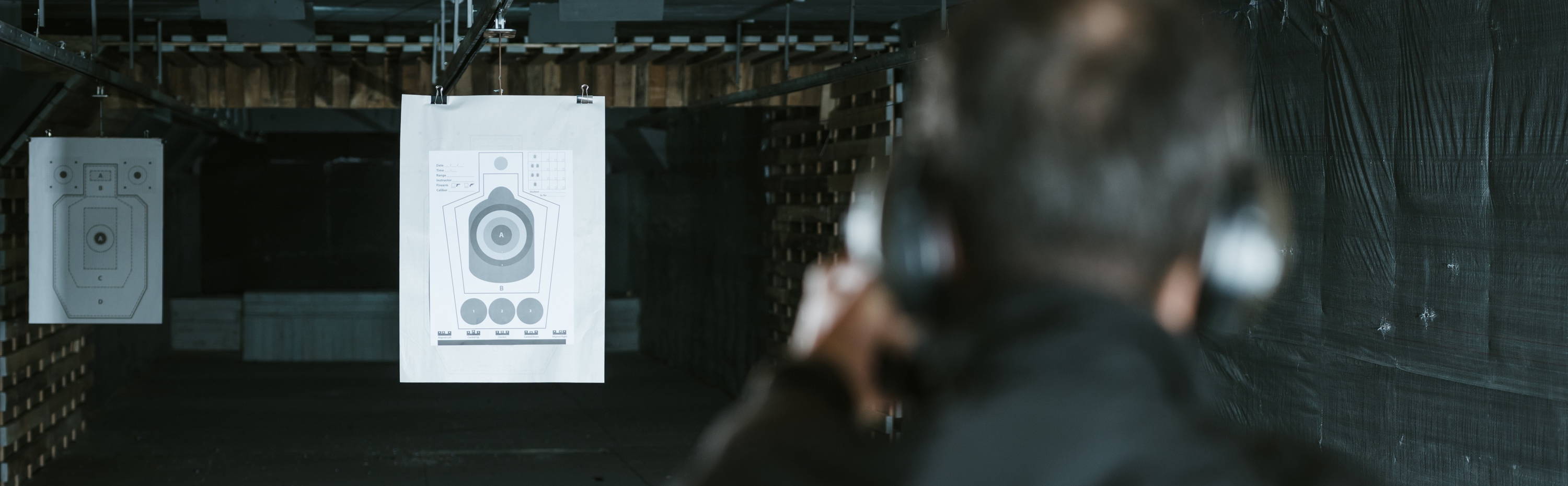 Man shooting targets at indoor shooting range