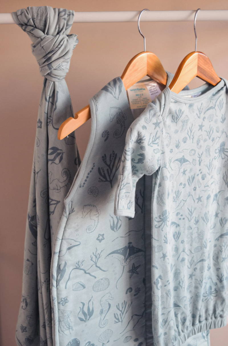 Woolbabe tide seascape sleepwear hanging on rack - merino / organic cotton sleepwear for babies