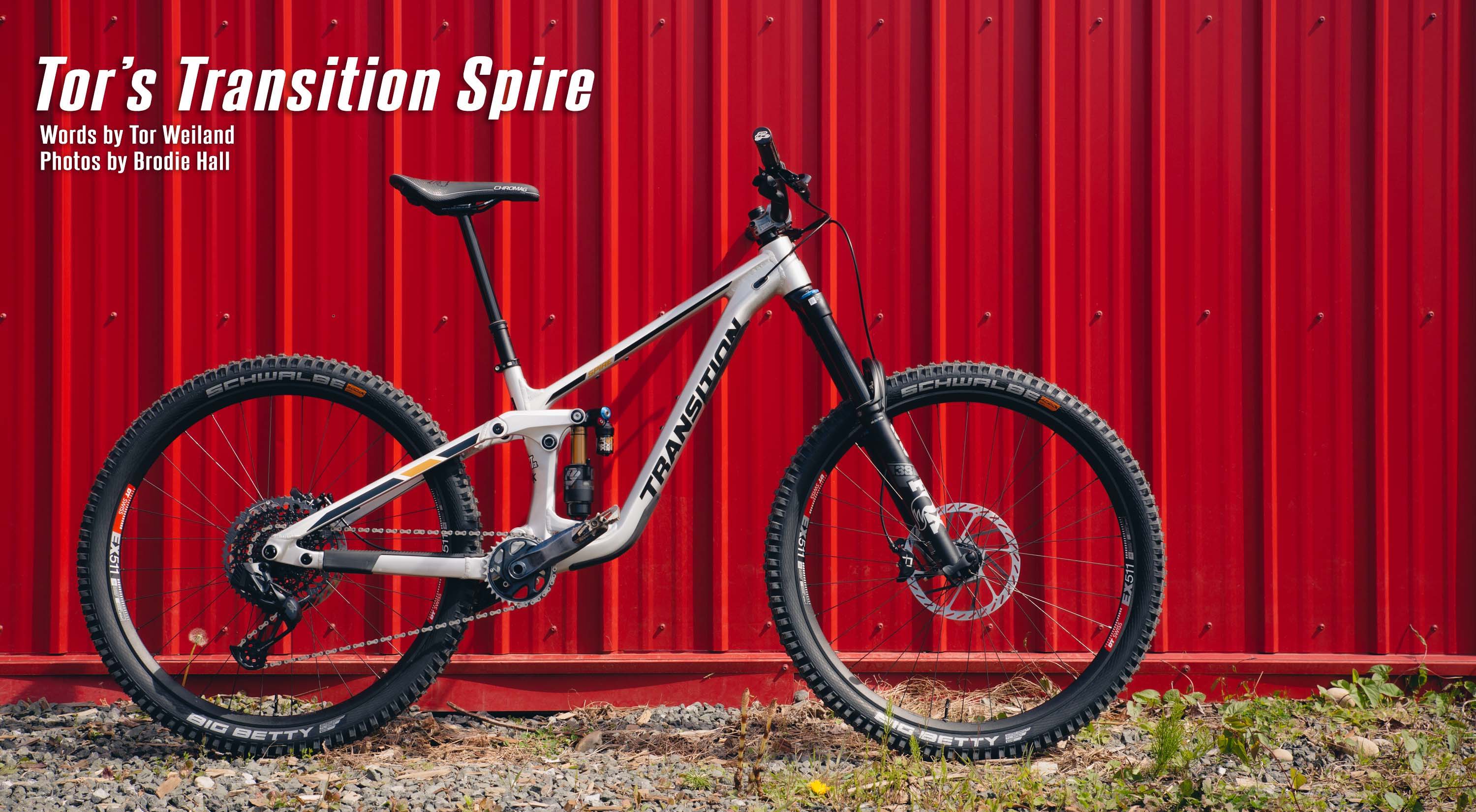 Transition Spire custom build on a red shipping container with sram gx axs fox float x2 fox 38 performance series elite schwalbe tires and oneup components