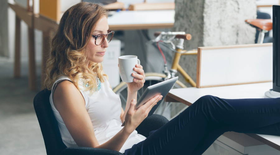 woman at desk drinking coffee