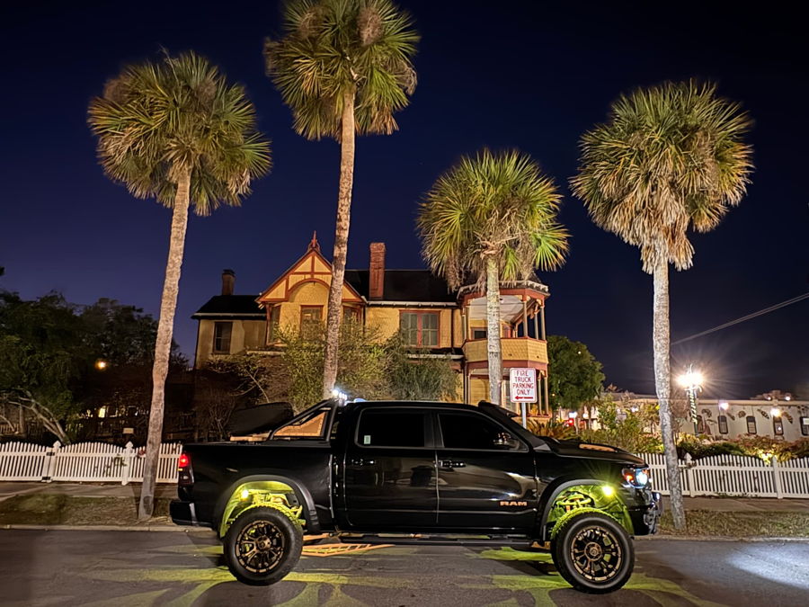 Side profile at night Pedro's 2021 Ram Bighorn 1500 with green underglow lifted wheels and bed rack HornBlasters gallery photo 3