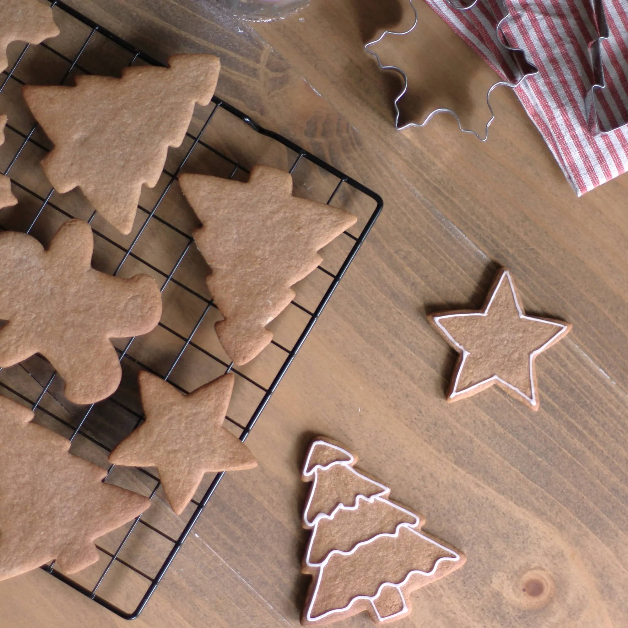 Cooling biscuits fresh out of the oven and being decorated with white icing