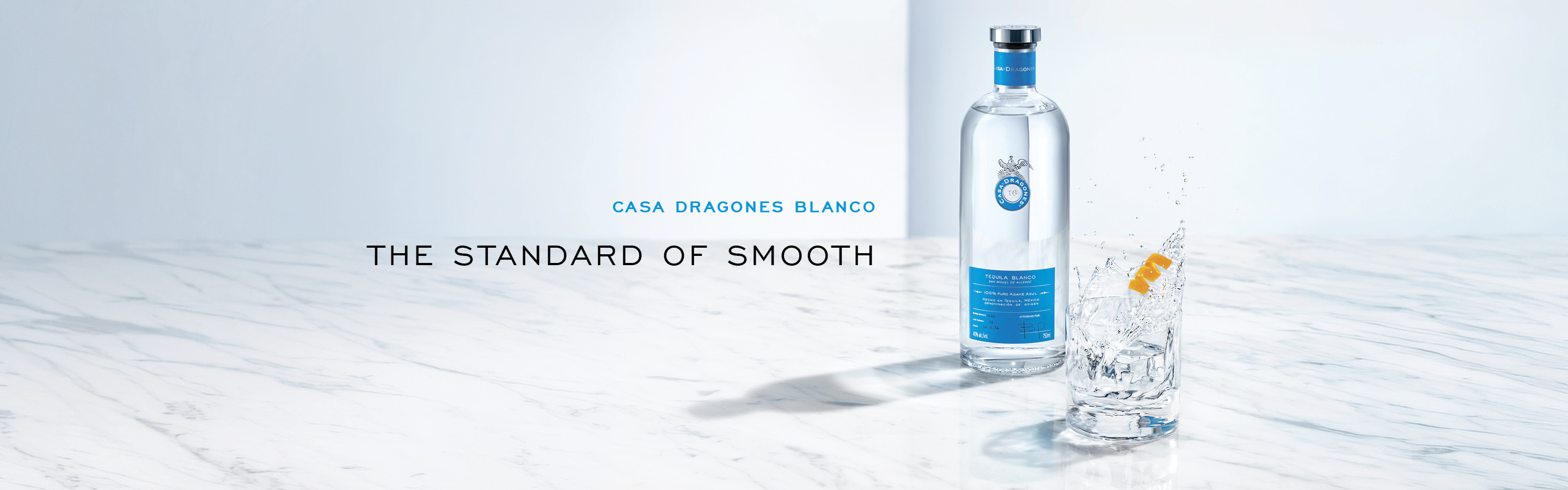 Bottle of water with a glass and ice, featuring promotional text.