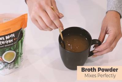 stirring broth in a mug