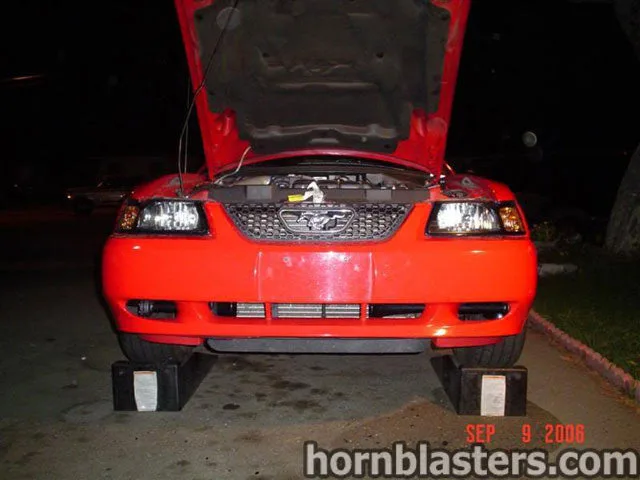 Front angle of 2003 Ford Mustang with Shocker XL train horn kit HornBlasters gallery photo 3