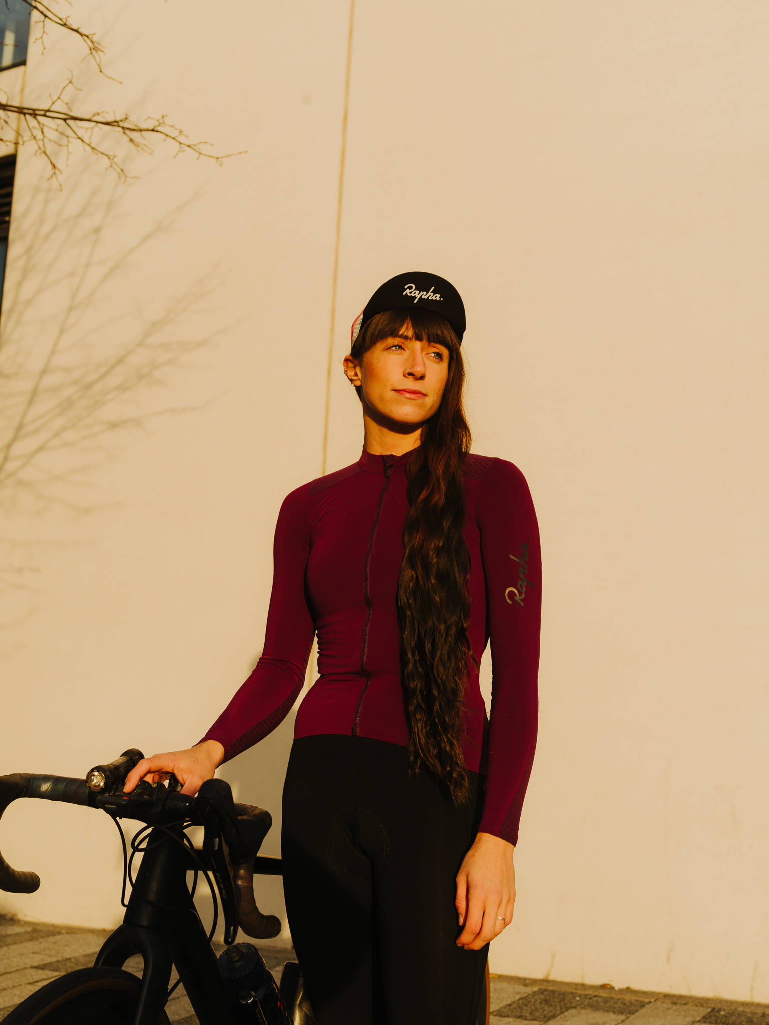 Jess Money standing in front of a building with her bike