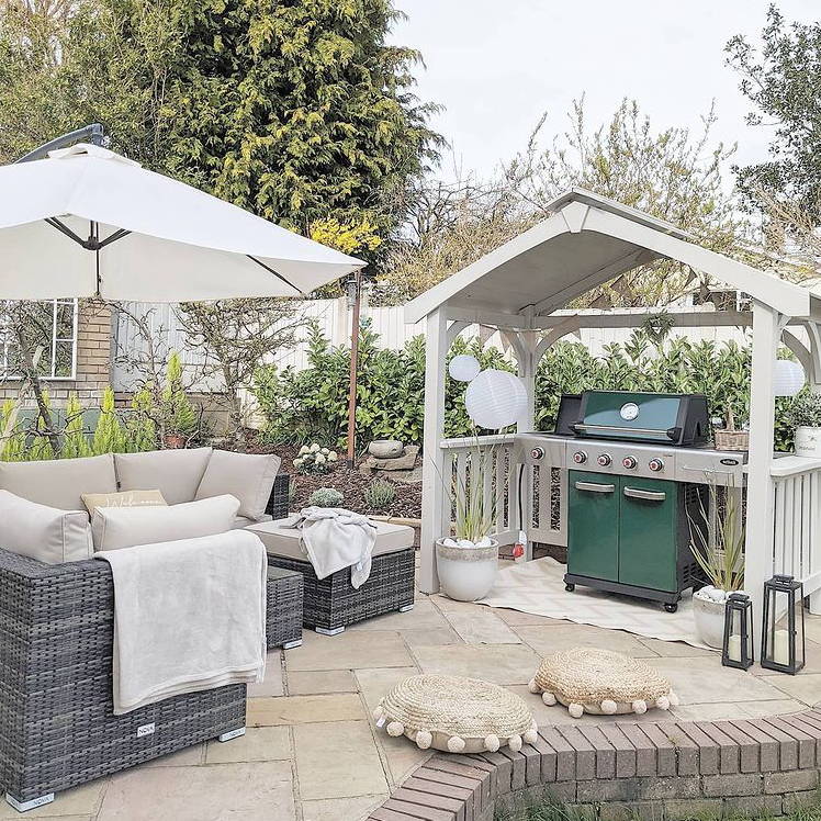 Customer garden photo featuring a garden set and BBQ displaying lanterns