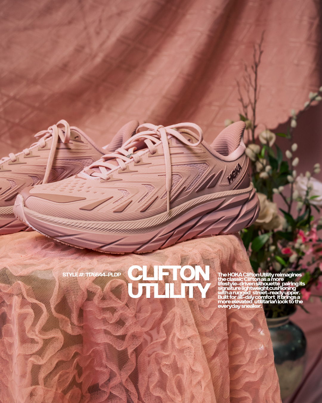 Pink athletic shoes on a textured surface with floral background.