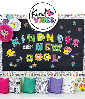 Bright classroom wall and seating area decorated with Kind Vibes classroom borders and Kindness is the New Cool bulletin board set