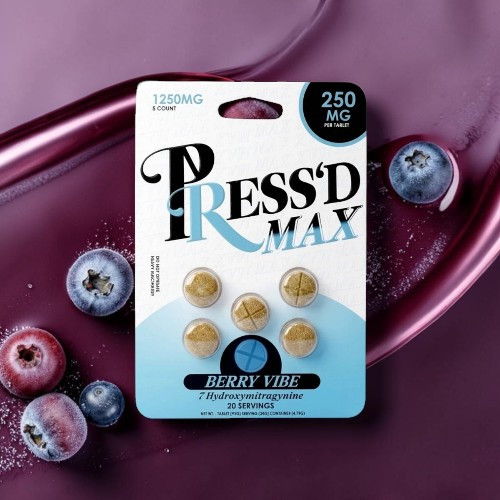 Press'd Max supplement packaging with blueberries on a purple background.