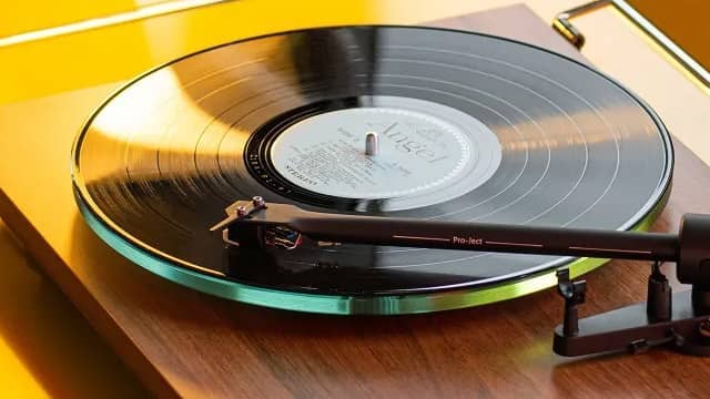 A vinyl record player with a spinning record on a colorful background.