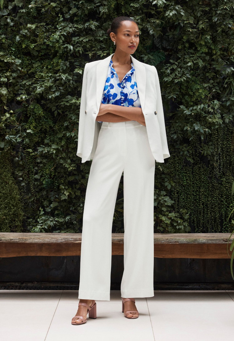 Model wearing ivory Clever Crepe suiting with blue and ivory floral Tierney blouse 