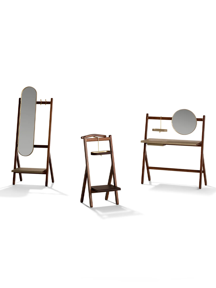 A standing mirror beside a chair and window in a modern room.