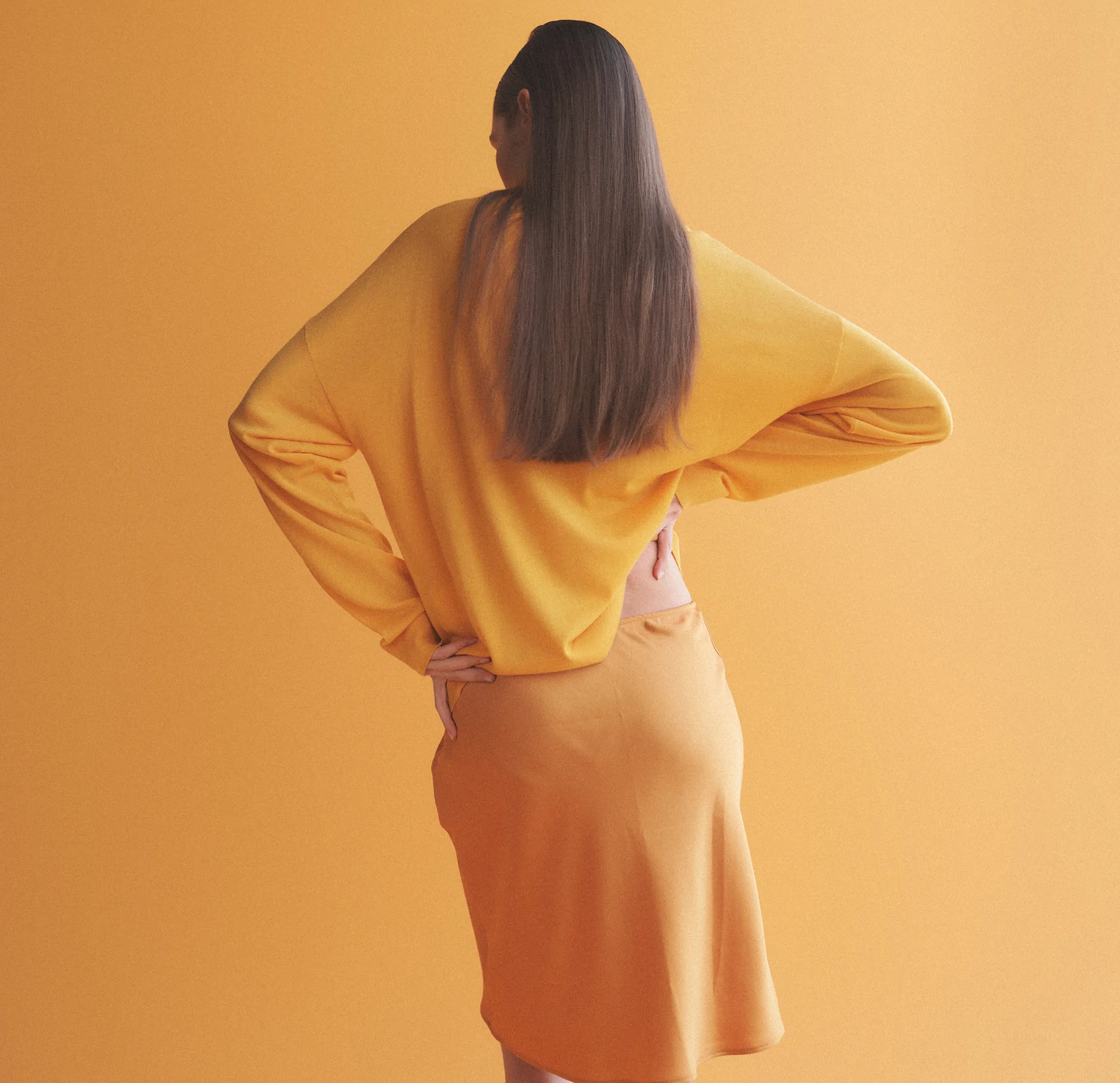 back of woman with hand on hips