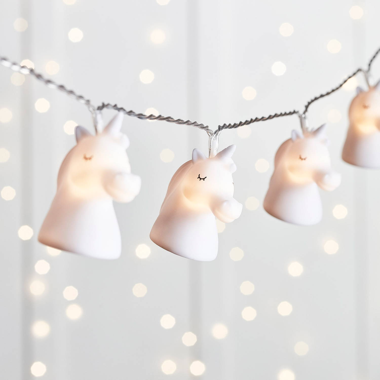 Unicorn fairy lights illuminated with twinkly backdrop