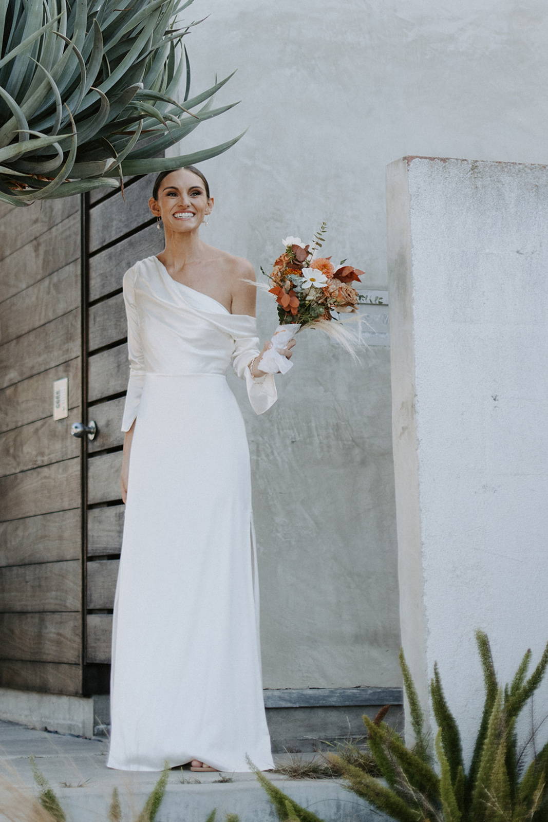 Bride smiling, holding her flowers
