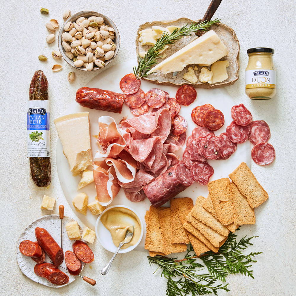 Assorted meats, cheeses and complements arranged on a table