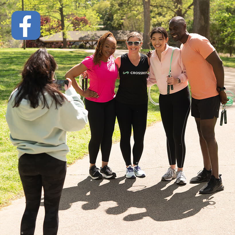 Group of friends posing for a photo in a park.