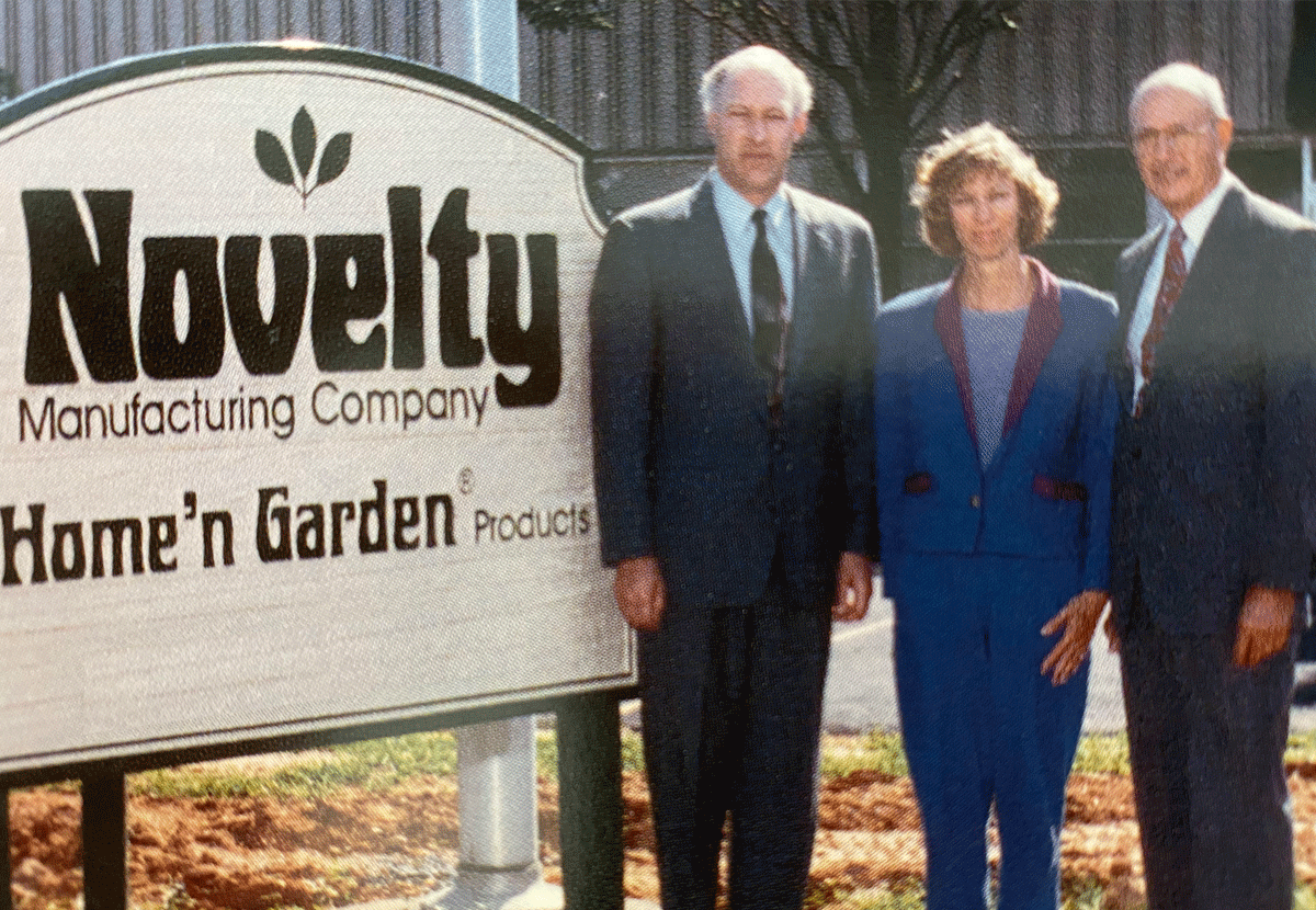 Photograph of Bill Jr., his son Timothy Winger, and Tim's sister Melinda Winger next to company sign