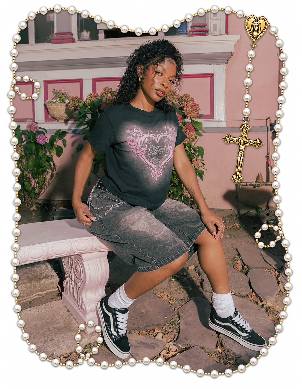 Person sitting on a bench, wearing a heart graphic t-shirt and shorts.