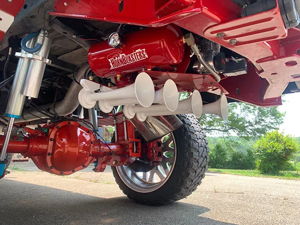 HornBlasters air tank and five white train horns installed on Corbin's red-painted rear suspension and differential