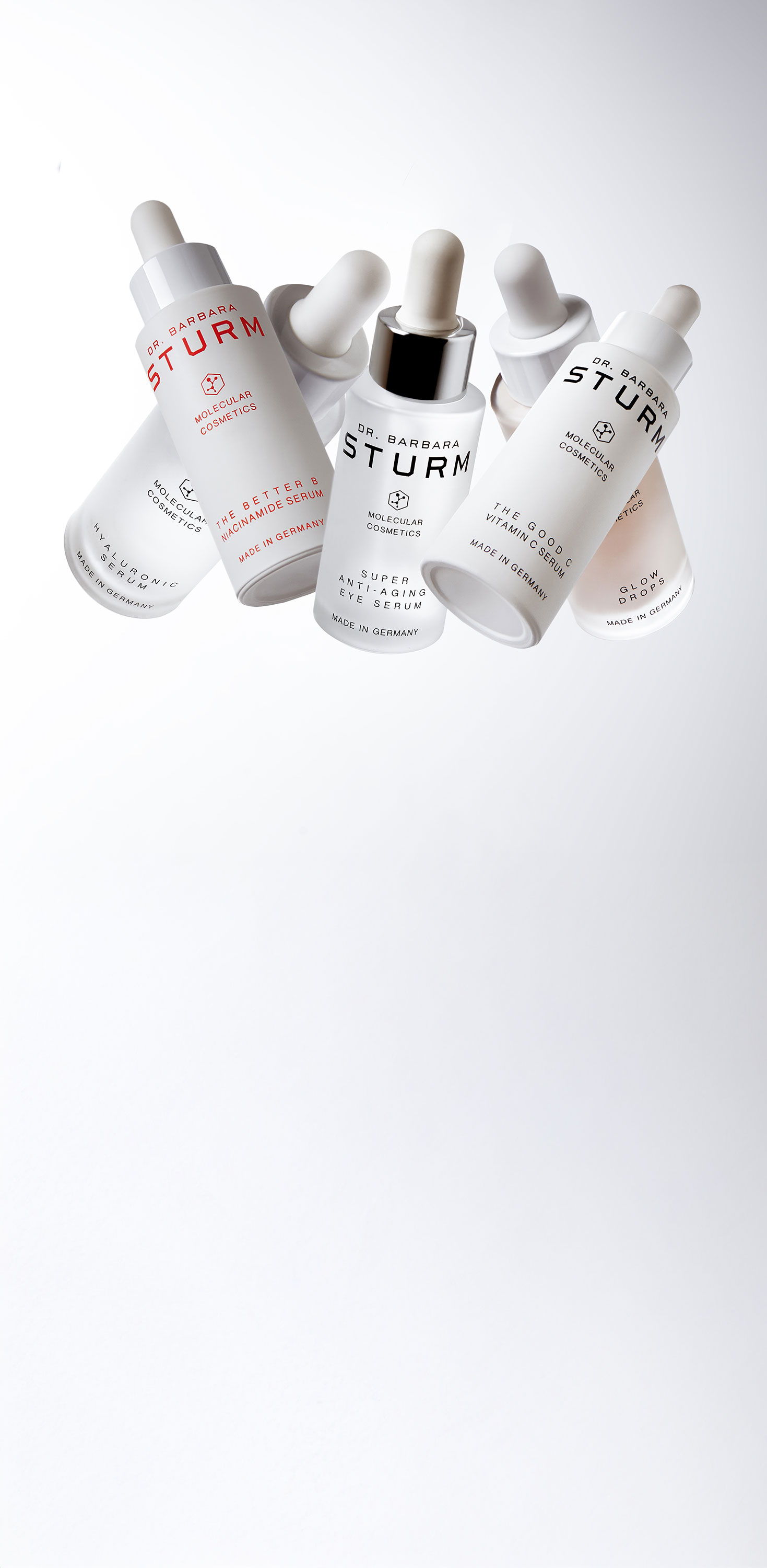 Five skincare serum bottles arranged artistically against a white background.