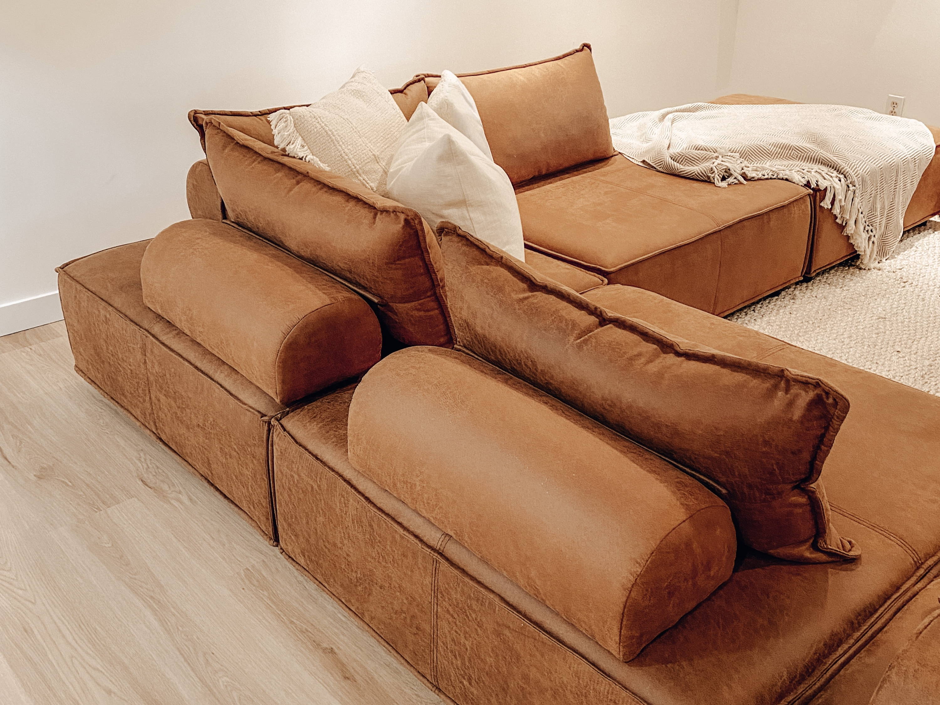 The corner of a brown sectional.
