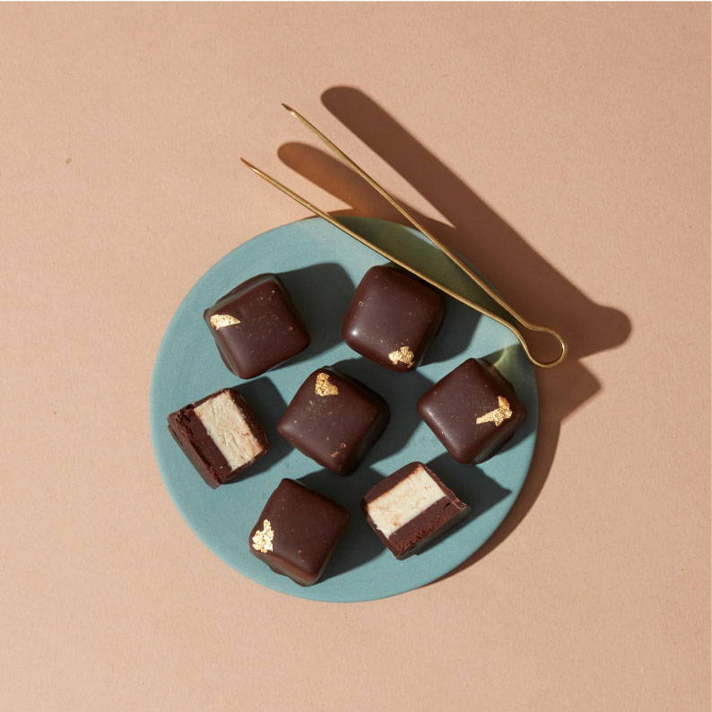 A dish of seven bonbons with tongs
