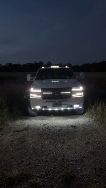 Night front view of James' white 2001 Chevrolet Silverado 2500HD with roof and bumper lights illuminated, install photo 3