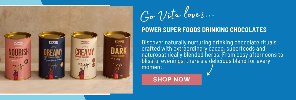 Four cans of powdered food and chocolate products on a blue background.