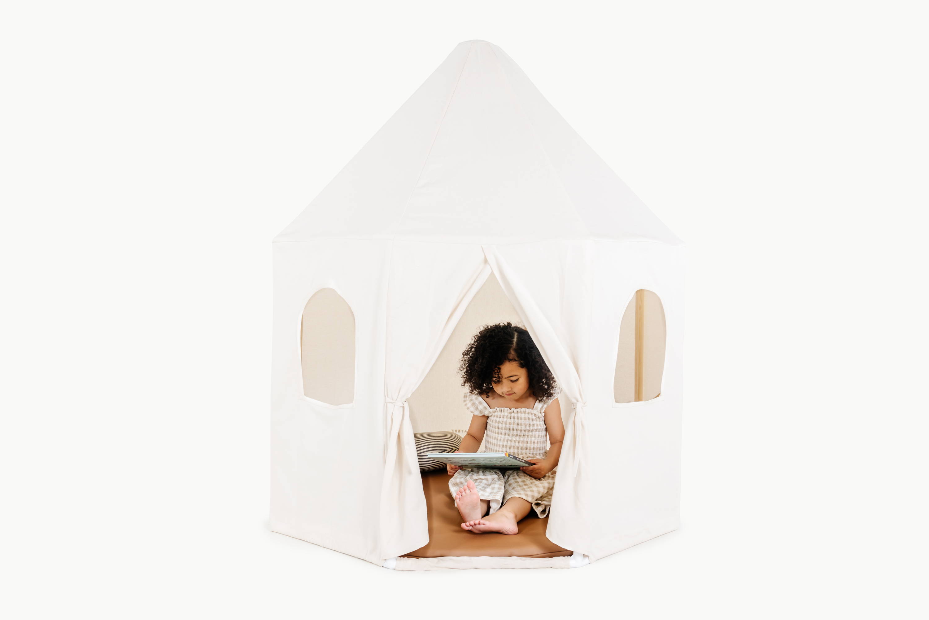 Girl reading book inside of Gathre Play Tent