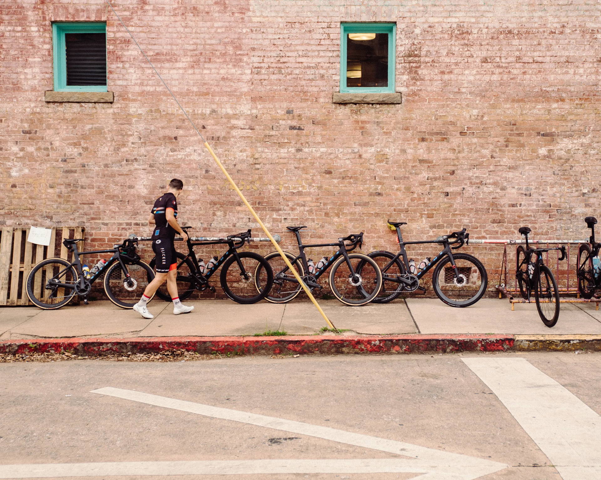Team Flicker Racing bikes against a brick wall