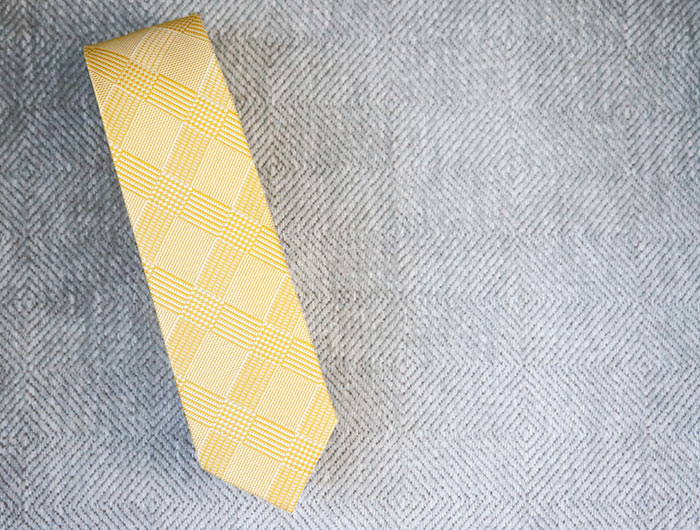 Yellow plaid tie on a gray background