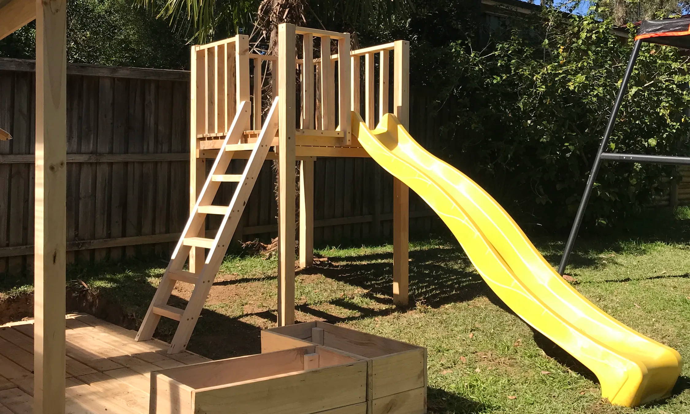 A raised platform cubbies with ladders and slides designed for families