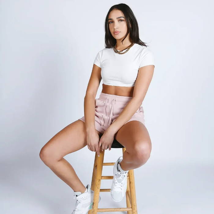 pink sacre fleece shorts on model sitting