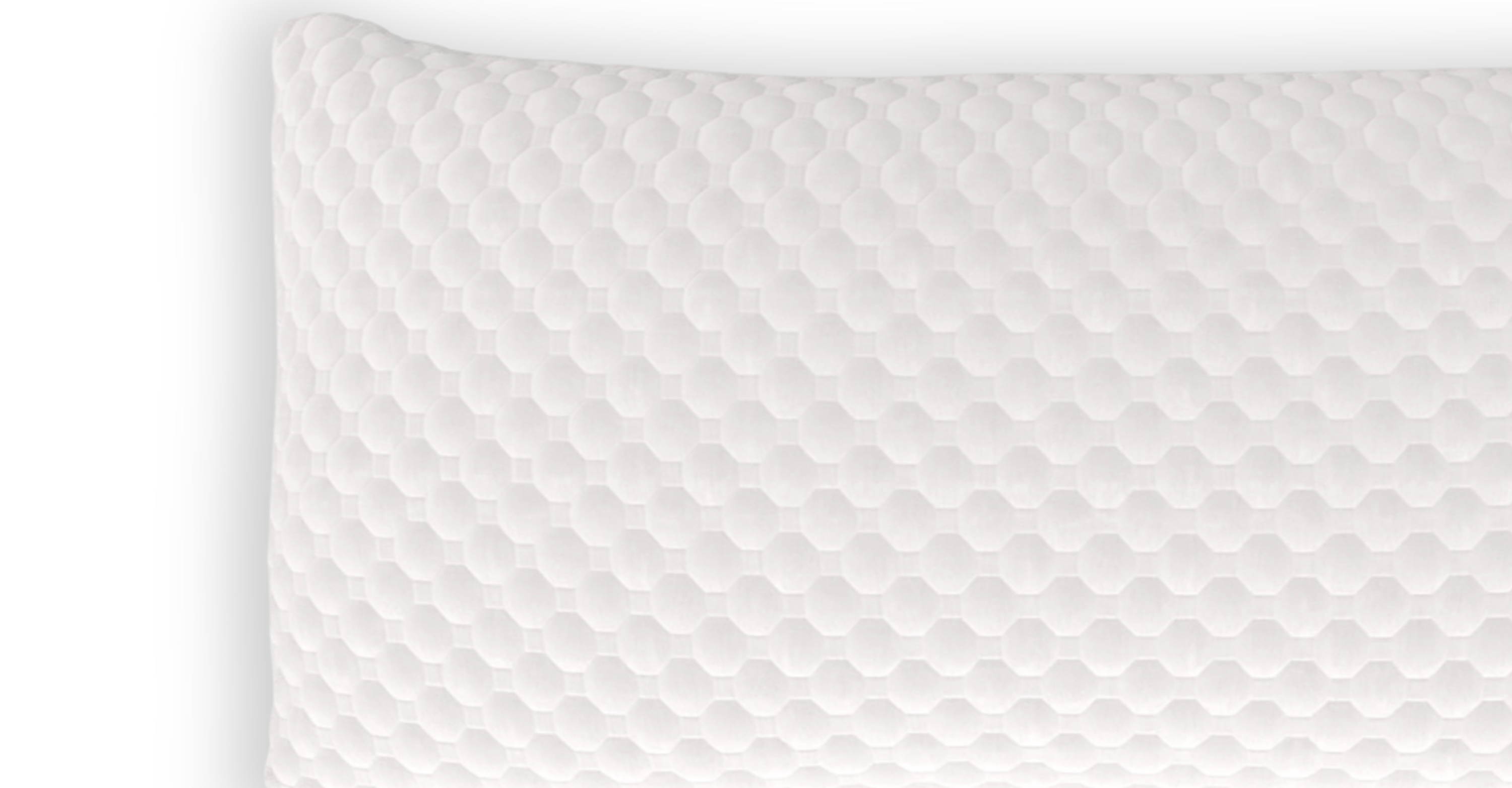 A close up of the CBD Pillow with a soft white quilted cover. 