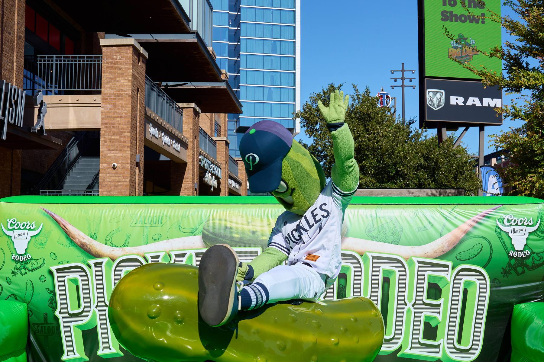 Portland Pickles mascot Dillon T. Pickle riding the Coors Banquet Pickle Rodeo bull at The Big Dill Arlington Texas 2025.