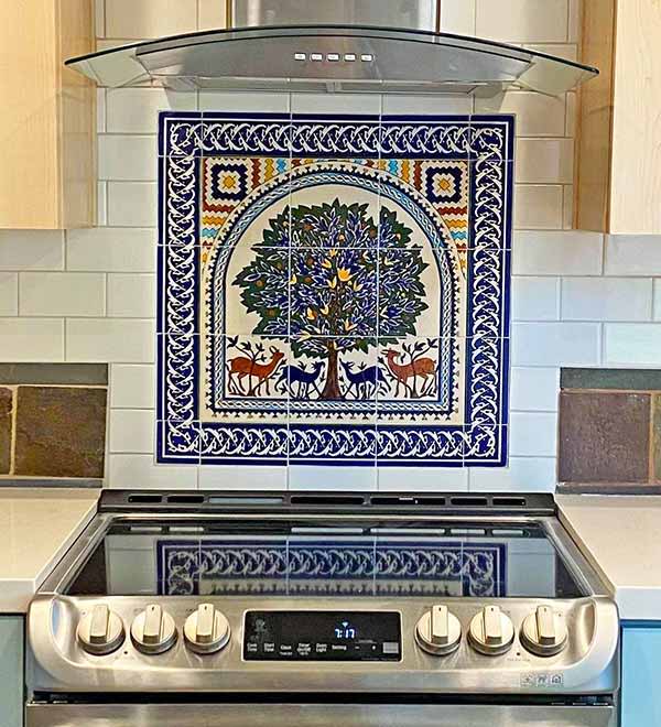 Tree of life tile mural in a kitchen wall backsplash