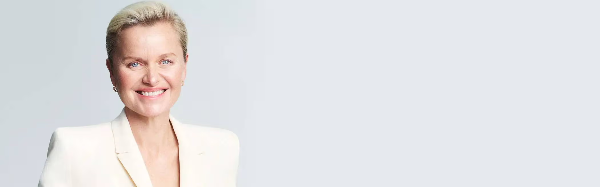 A banner image of Dr Sturm, smiling in a light-colored blazer against a plain background.