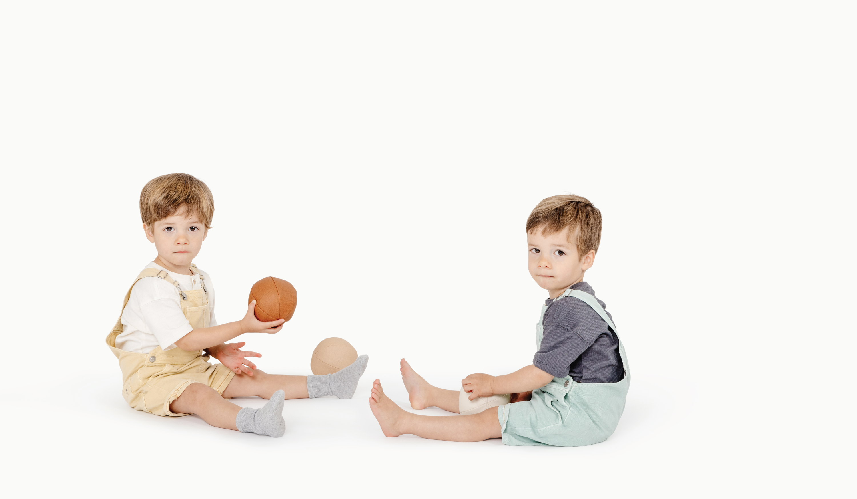 Boys sitting on the floor playing with Gathre Play Balls