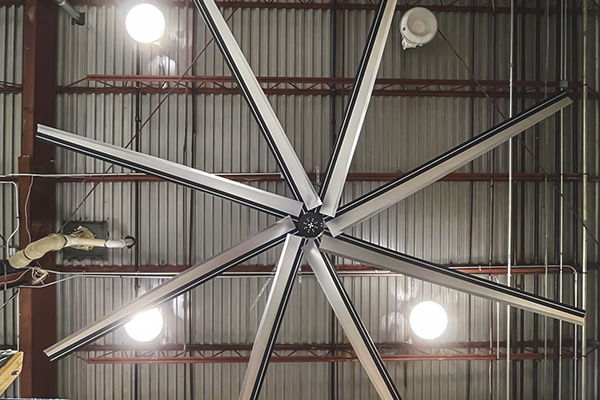 Large Gray HVLS Fan hanging from ceiling.
