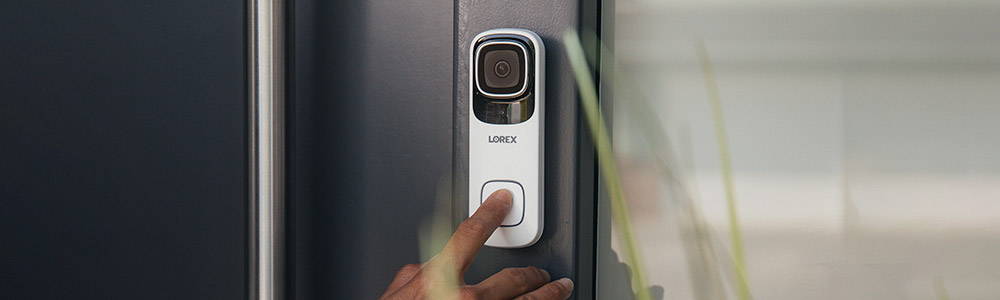 Finger pressing Lorex Smart Video Doorbell