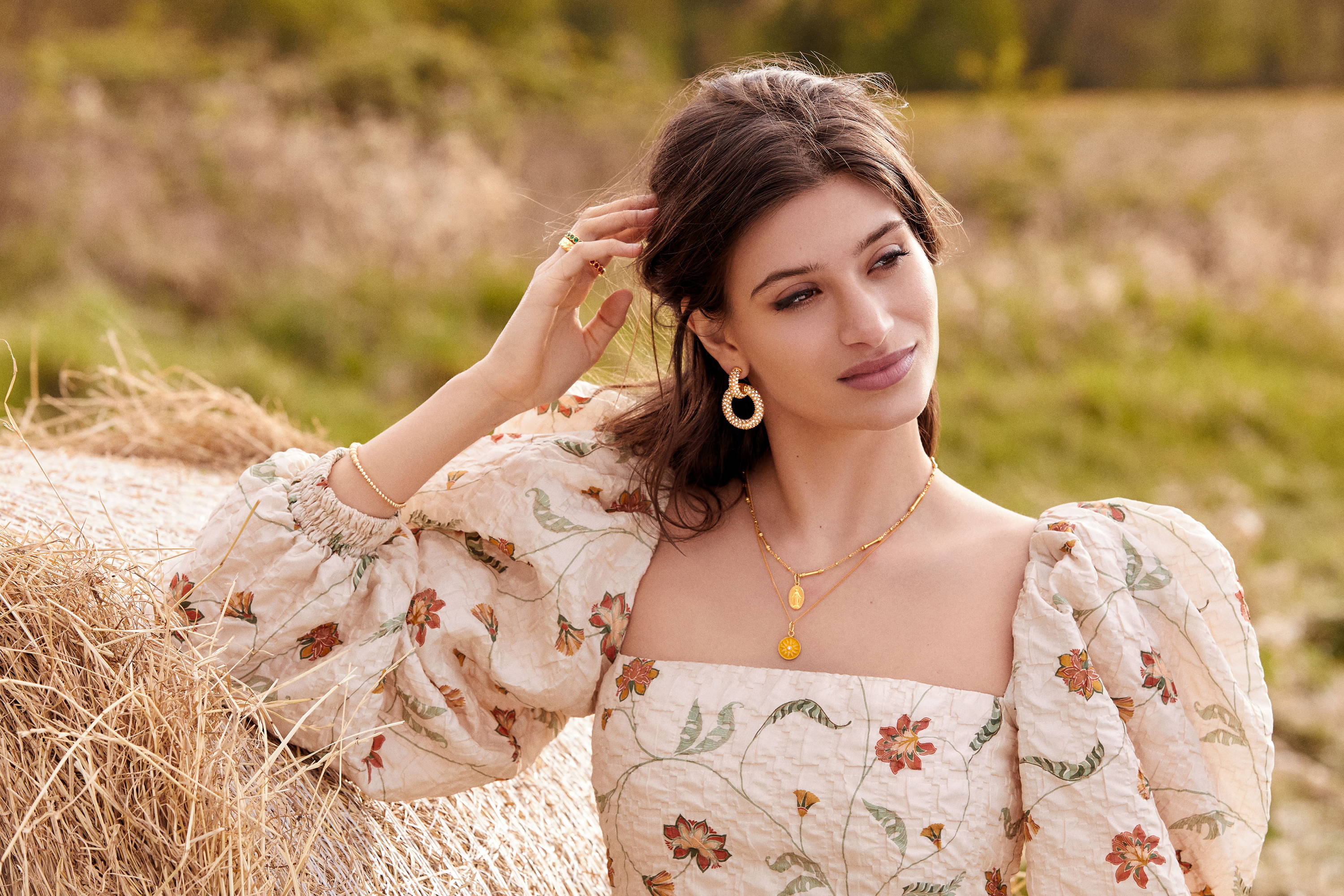 Cairo wears the Giovanna Earrings, Mini Pellegrino Necklace, Isola Bella Necklace, Graziella Bracelet, Green Etruria Ring, Red Etruria Ring and Laurel Ring