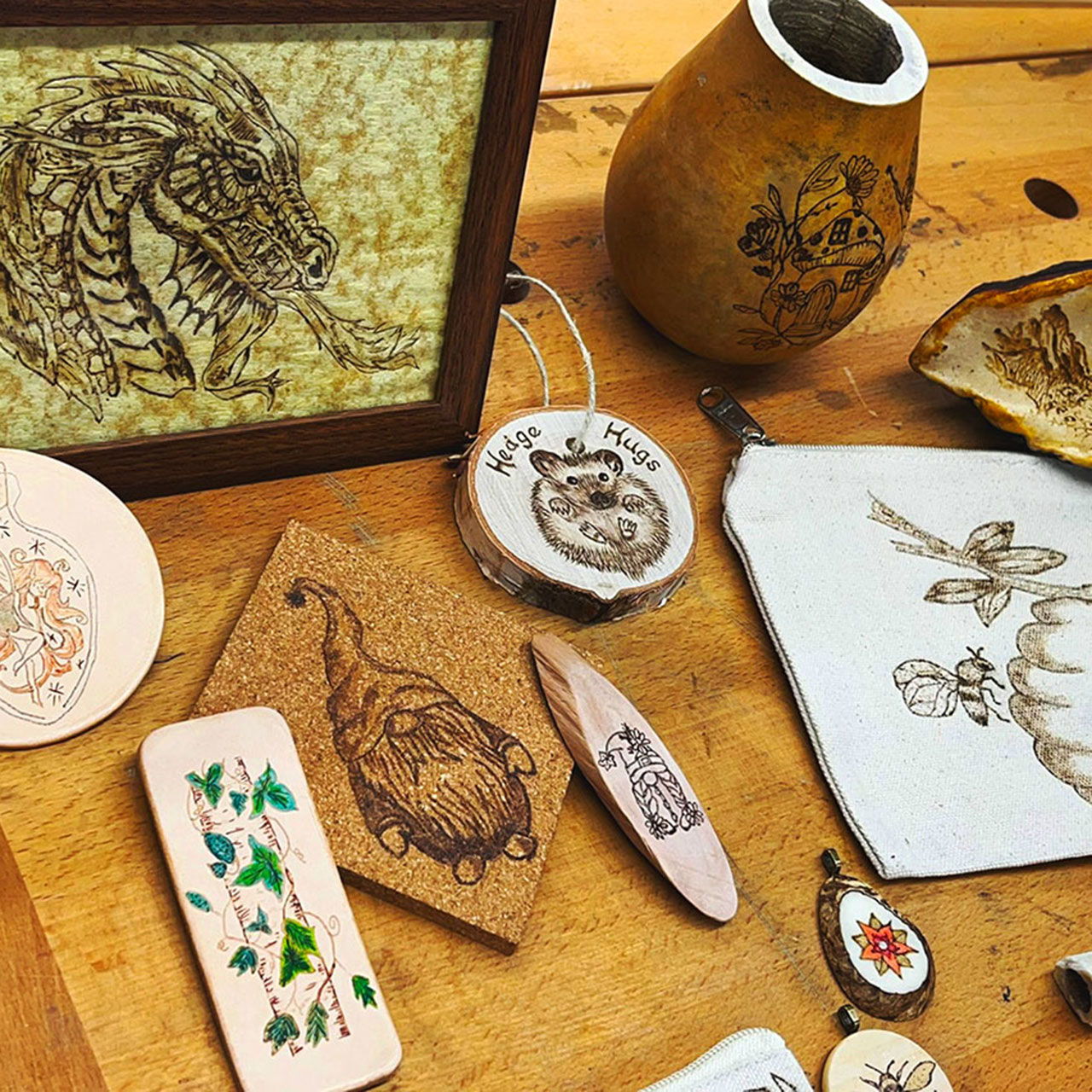 Assorted handcrafted items, including woodburned art and decorative objects.