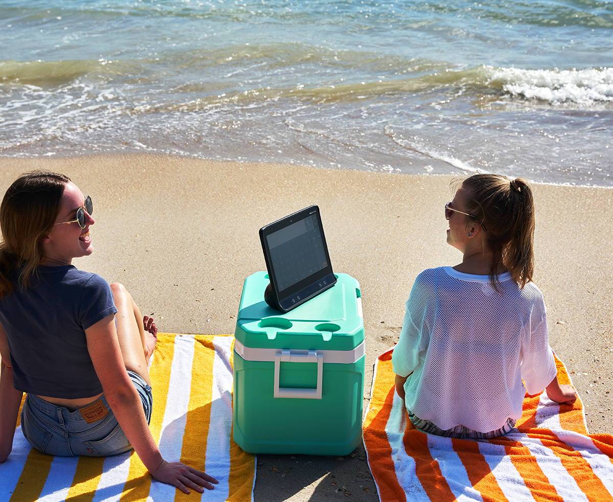 Woman using her Tobii Dynavox TD I-16 device at the beach