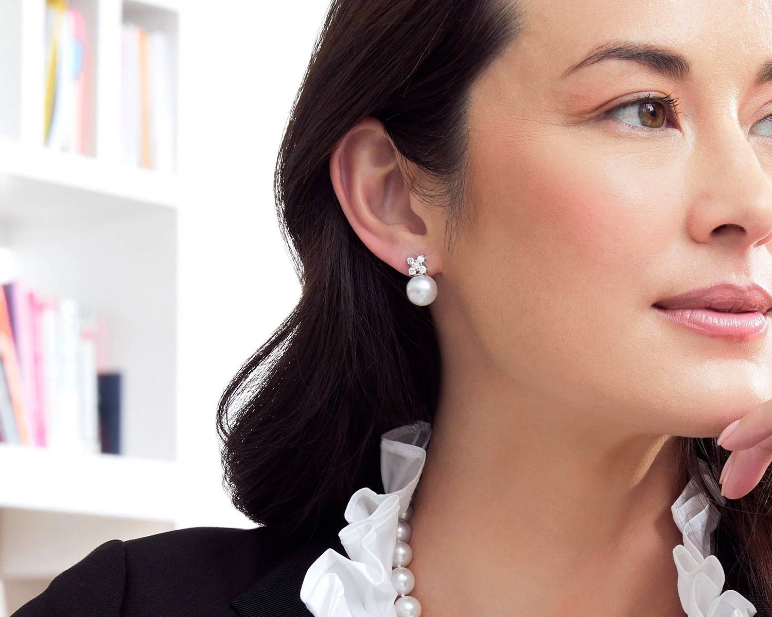 White South Sea Pearl and Diamond Stud Earrings on a Model with Dark Hair
