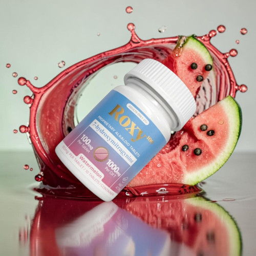 Bottle of supplements with watermelon slices and splashing juice.