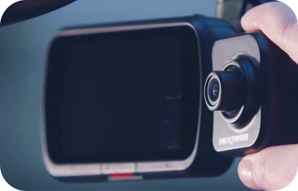 A person holding a camera with a lens and screen.